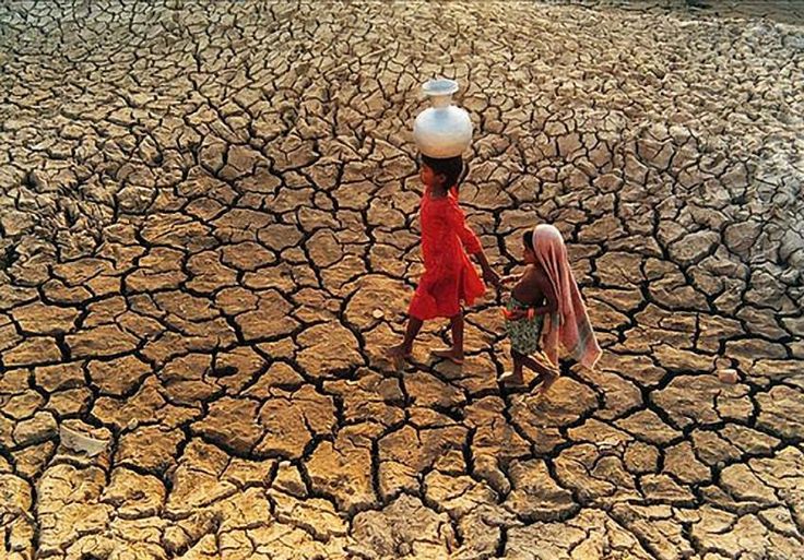 A person drinking directly from a contaminated open water source in Sub-Saharan Africa